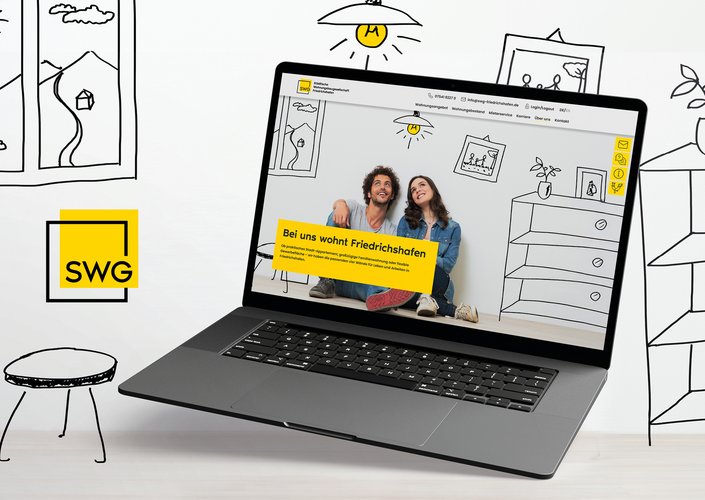 Laptop zeigt Website der SWG mit drei jungen Menschen vor gezeichneter Wohnzimmereinrichtung, zentrale Botschaft: „Bei uns wohnt Friedrichshafen“.